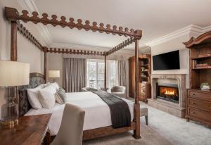 a bedroom with a canopy bed and a fireplace at Liora Estate in Healdsburg