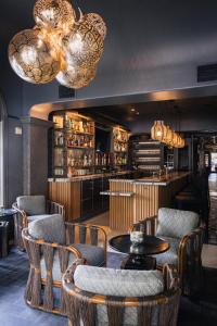 a restaurant with chairs and a table and a bar at Liora Estate in Healdsburg