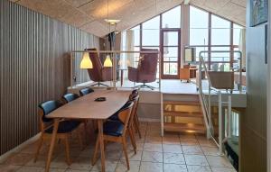 a dining room with a table and chairs and a window at Marina Minde in Egernsund