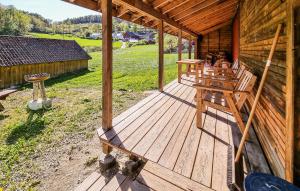 an outside deck of a log cabin with a grill at Sjøhytta in Vanvik +11 photos