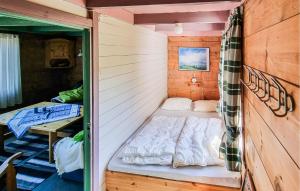 a small room with a small bed in it at Sjøhytta in Vanvik