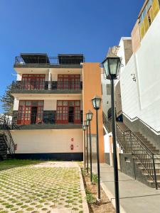 a building with stairs and a street light in front at Andari Hoteles in Arequipa