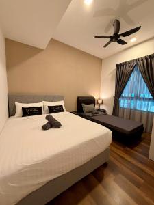 a bedroom with a bed with a teddy bear on it at Sunway Onsen Ipoh by EUcation Hospitality in Tambun +63 photos