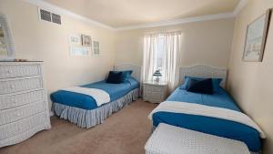 a bedroom with two beds and a dresser at West Cape Estate in West Cape May