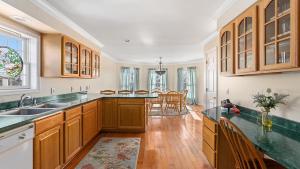 a kitchen with wooden cabinets and a dining room at West Cape Estate in West Cape May