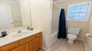 a bathroom with a sink and a toilet and a window at West Cape Estate in West Cape May +30 photos