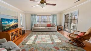 a living room with a couch and a tv at West Cape Estate in West Cape May