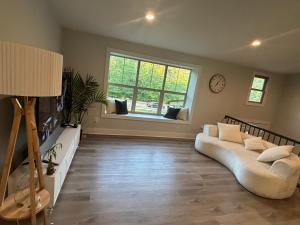 a living room with a white couch and a window at Cozy Rooms in Decatur in Decatur