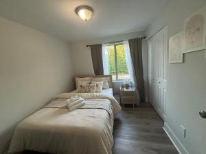 a small bedroom with a bed with a window at Cozy Rooms in Decatur in Decatur