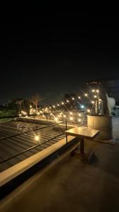 a bench sitting on top of a building at night at Villa Moon Terrace in Bang Khen
