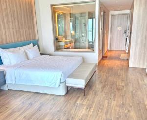 a bedroom with a large bed and a large mirror at À La Carte Hạ Long in Ha Long