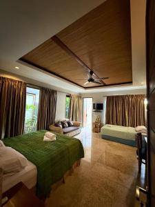 a bedroom with two beds and a ceiling at Bayshore Residence in Candidasa +83 photos