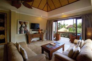a living room with a couch and a table at Bayshore Residence in Candidasa