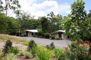 a pair of houses in a garden at Boonah Valley Motel in Boonah
