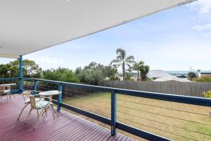 a balcony with a table and chairs on a deck at Bay View in Portarlington