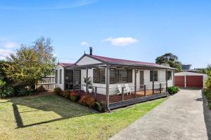 a house with a porch and a yard at Bellarine Beach Shack in Saint Leonards