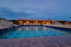 a large swimming pool with a building in the background at Posada de las Flores Loreto in Loreto
