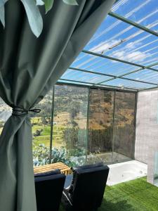 a glass house with a view at Cabaña Bambú - Roca Glamping Suesca in Santa Isabel