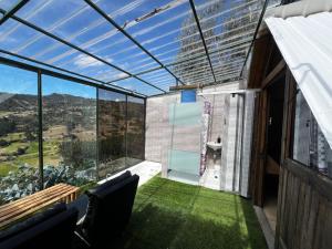 a balcony with a view of a building at Cabaña Bambú - Roca Glamping Suesca in Santa Isabel