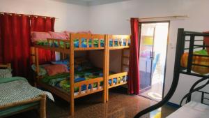 a room with two bunk beds in a room at Poseidon White Sand Resort & Cave in Santa Rosa