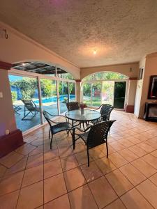 a dining room with a table and chairs on a patio at Cozy beach house getaway in La Libertad