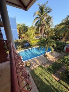 a view of a swimming pool from the balcony of a house at Cozy beach house getaway in La Libertad