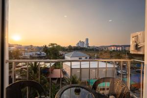 a balcony with chairs and a view of a city at Aslan Boutique Apartments in Patong Beach