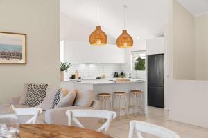 a kitchen and living room with a couch and a table at Southwind in Sunrise in Sunrise Beach