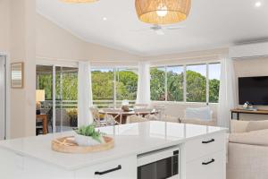 a kitchen and living room with a couch and a table at Southwind in Sunrise in Sunrise Beach +27 photos