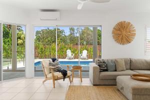 a living room with a couch and a pool at Southwind in Sunrise in Sunrise Beach
