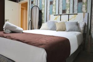 a bedroom with a large white bed with pillows at Molejo Guest House in Palatswe