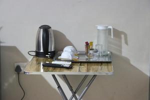 a table with a lamp and a remote control on it at Molejo Guest House in Palatswe +69 photos