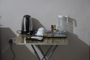 a glass table with a coffee maker and a coffee pot at Molejo Guest House in Palatswe