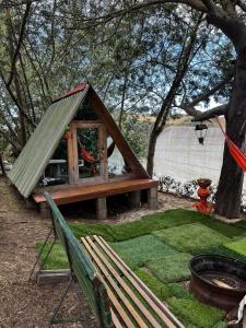 a play house with a hammock and a tree at Mini Cabaña Roca Glamping in Suesca