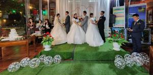 a group of people standing in front of a wedding cake at Ninh Binh Mountain View Homestay & Restaurant in Ninh Binh