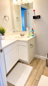 a bathroom with a white sink and a mirror at Penn Signature Airport Short Term Rental PHX in Phoenix +27 photos