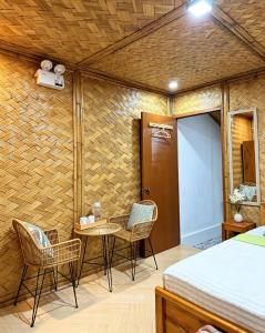 a bedroom with a bed and chairs and a table at Sirem Beach Resort in Puerto Princesa City +53 photos
