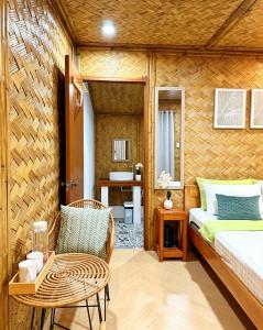 a room with a bed and a table and a chair at Sirem Beach Resort in Puerto Princesa City