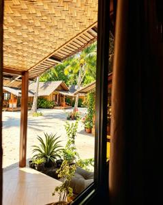 a view from a window of a house with plants at Sirem Beach Resort in Puerto Princesa City