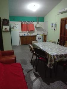 a kitchen with a table and chairs in a room at Cabañas El Monchito in Juana Koslay 