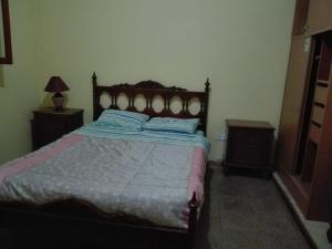 a bedroom with a bed and two nightstands at Cabañas El Monchito in Juana Koslay 