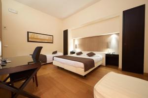 Postel nebo postele na pokoji v ubytování Hotel Cosimo de' Medici