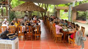 a group of people sitting at tables in a restaurant at Ninh Binh Mountain View Homestay & Restaurant in Ninh Binh