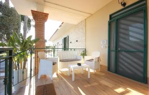 a door on a balcony with white chairs and a table at Villa Angela Holiday Apartment in Angri