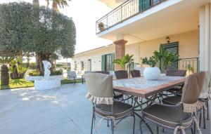 a patio with a wooden table and chairs at Villa Angela Holiday Apartment in Angri