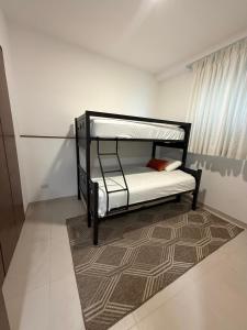 a black bunk bed in a room with a rug at Paradise in a rainforest reserve B 503 in Playa del Carmen +22 photos