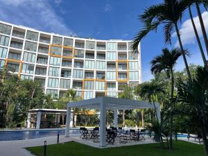 a hotel with a gazebo in front of a building at Paradise in a rainforest reserve B 503 in Playa del Carmen