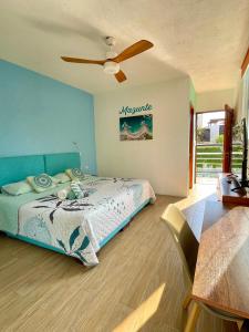 a bedroom with a bed and a ceiling fan at Casa Menta in Puerto Escondido +42 photos