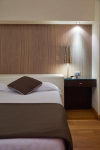 Postel nebo postele na pokoji v ubytování Hotel Cosimo de' Medici