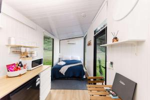 a bedroom in a tiny house with a bed and a desk at Montville Retreat by Tiny Away in Montville +37 photos